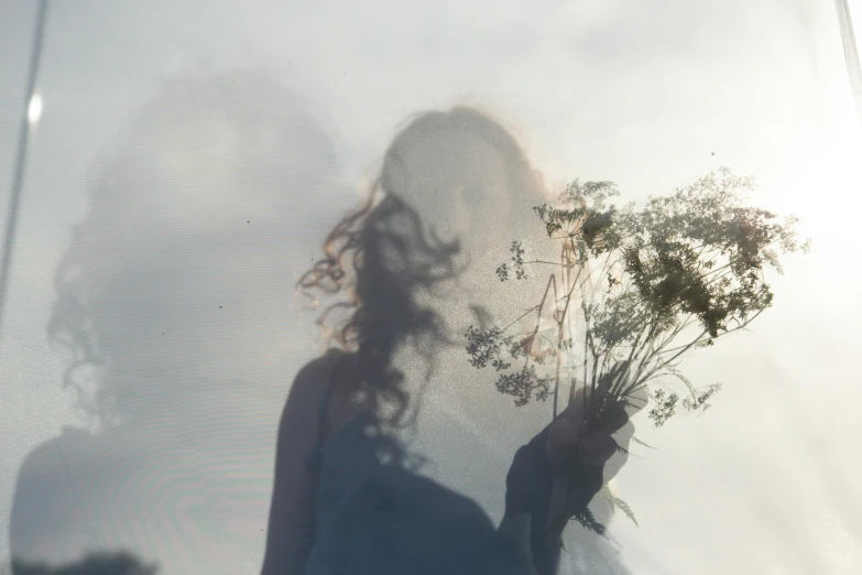 a woman holding a bunch of flowers in front of a window, unsplash, magical realism, in a misty pond, shadow play, floating into the sky, ignant