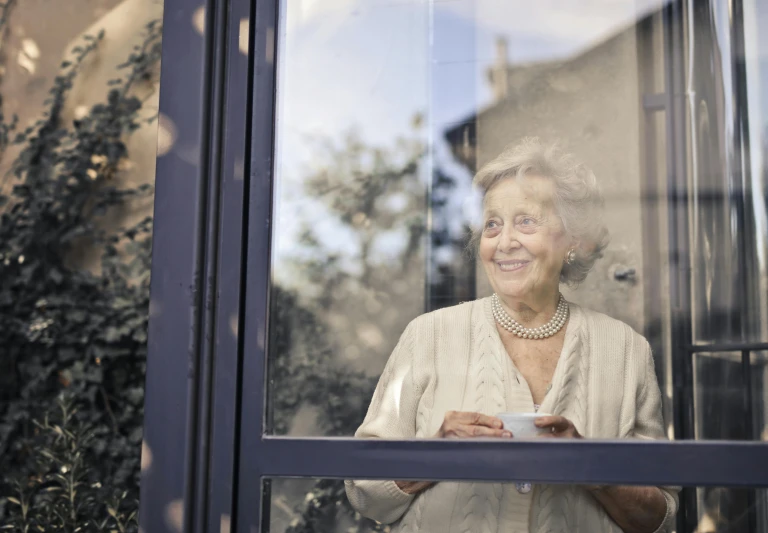 a woman that is looking out of a window, smiling slightly, old lady, french door window, 15081959 21121991 01012000 4k