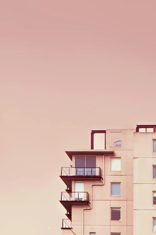a tall building with balconies on top of it, a photo, unsplash, postminimalism, pink hue, art print, sweet home, on rooftop