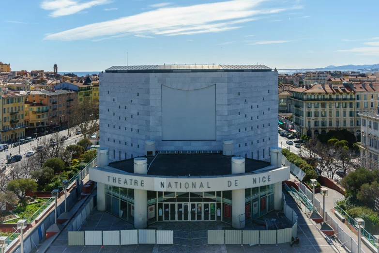 a large building sitting in the middle of a city, by Theo Constanté, theater, nice weather, 2022 photograph, wide aerial shot