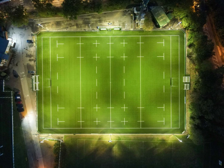 an overhead view of a soccer field at night, a digital rendering, by Adam Marczyński, unsplash contest winner, early morning lighting, square, beautiful natural light, high resolution ultradetailed