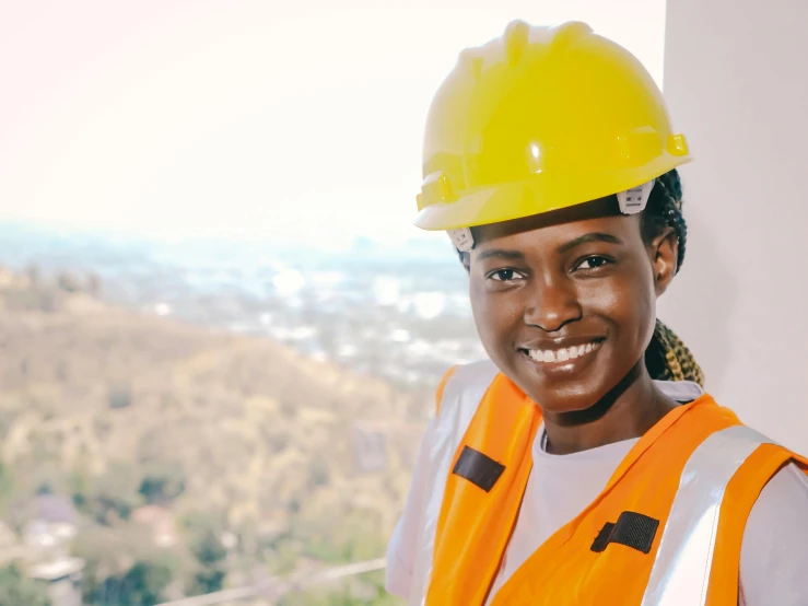 a woman wearing a hard hat and safety vest, pexels contest winner, renaissance, lupita nyong'o, avatar image, girl wearing uniform, overlooking