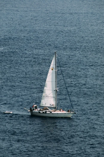 a sailboat in the middle of a large body of water, circa 1 9 9 9, manly, close up shot from the top, one small boat