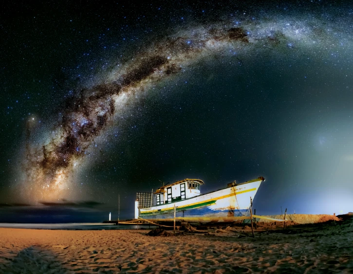 a boat sitting on top of a sandy beach, by Peter Churcher, unsplash contest winner, space art, arching milkyway, manly, fish-eye, under a night sky