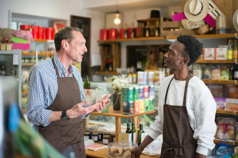 a couple of men standing next to each other in a store, pexels contest winner, renaissance, aussie baristas, ethiopian, convincing, al fresco