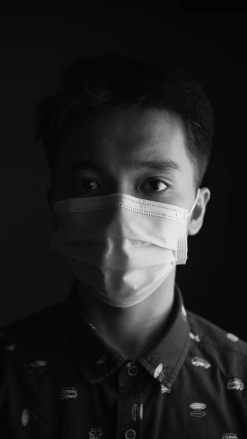 a black and white photo of a man wearing a face mask, pexels, detailed face of a asian boy, medic, square, a dark