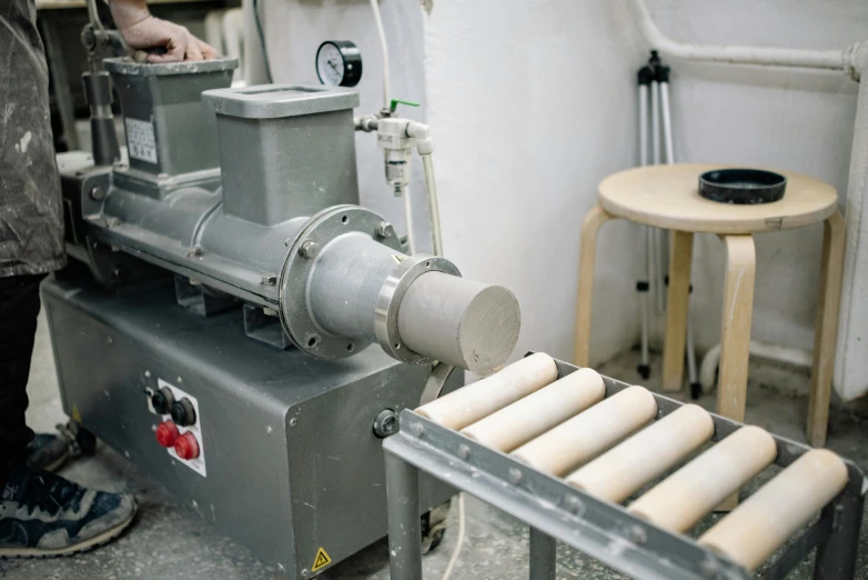 a man that is standing in front of a machine, white clay, baking french baguette, tubes fused with the body, grey