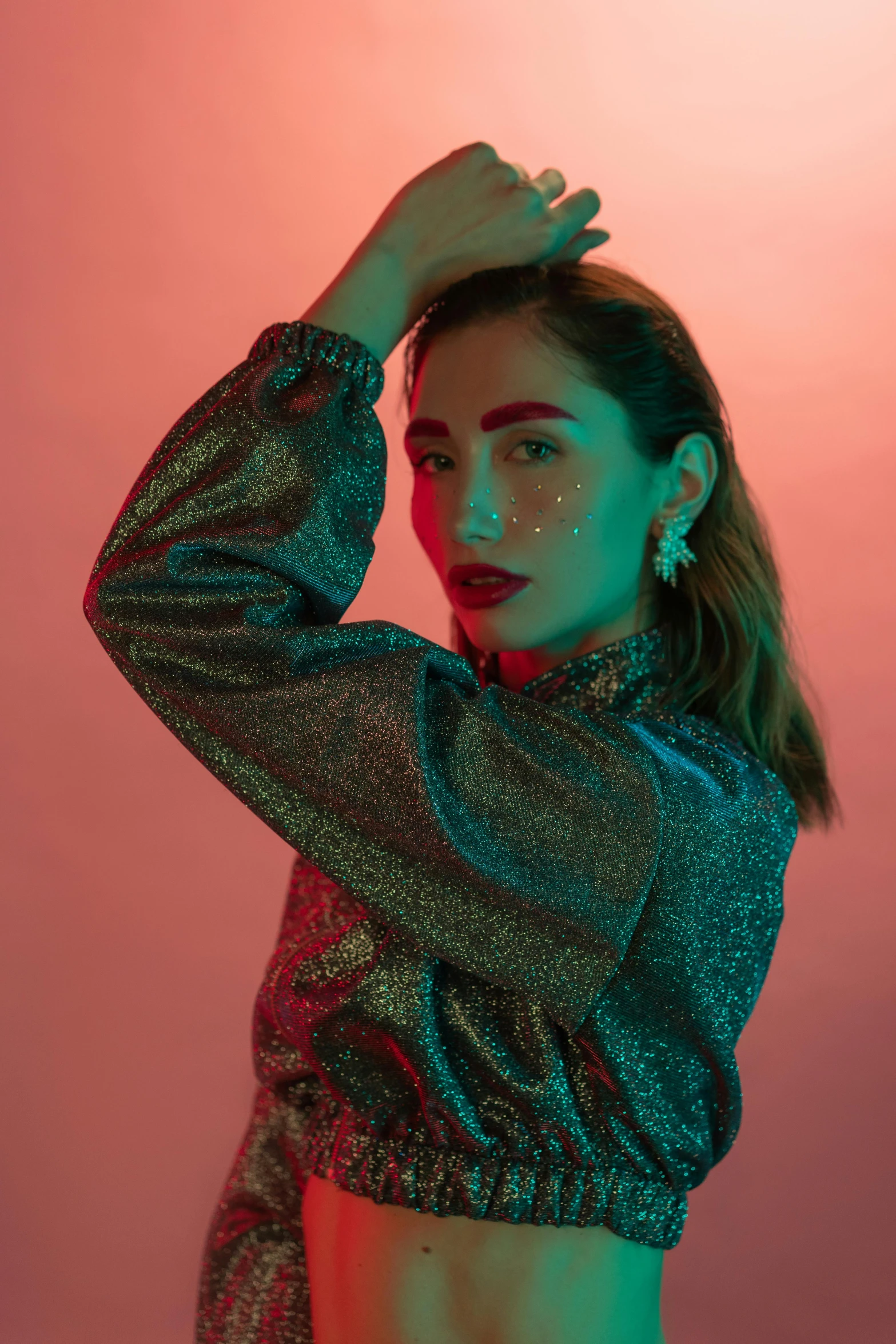 a woman standing in front of a pink background, inspired by Elsa Bleda, holography, flashy red lights, asian woman, doing a sassy pose, metallic flecks