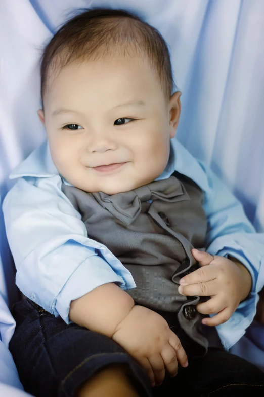 a close up of a baby wearing a shirt and tie, an album cover, by Basuki Abdullah, shutterstock contest winner, blue and gray colors, smiling at camera, mai anh tran, fully body shot