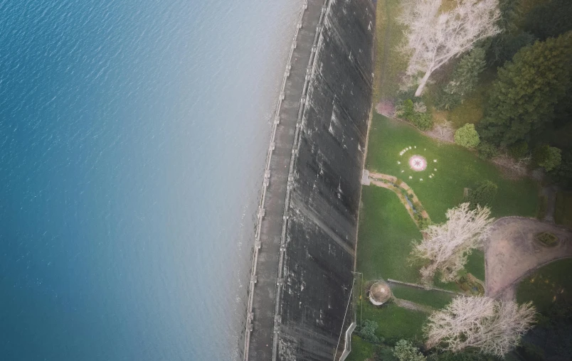 an aerial view of a dam in the middle of a lake, by Carey Morris, pexels contest winner, concrete walls, irrigation, half and half, seen from below