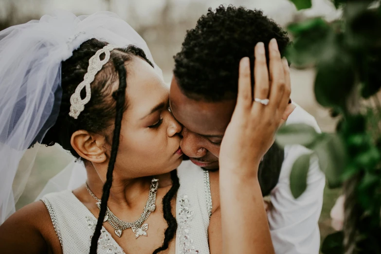 a bride and groom sharing a kiss on their wedding day, pexels contest winner, photo of a black woman, 1 4 9 3, romantic period, alana fletcher