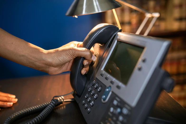 a close up of a person using a telephone, private press, in an call centre office, lights off, avatar image, thumbnail