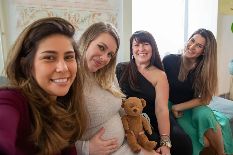 a group of women sitting next to each other, a photo, by Liza Donnelly, pexels contest winner, pregnant belly, avatar image, smiling at camera, profile pic