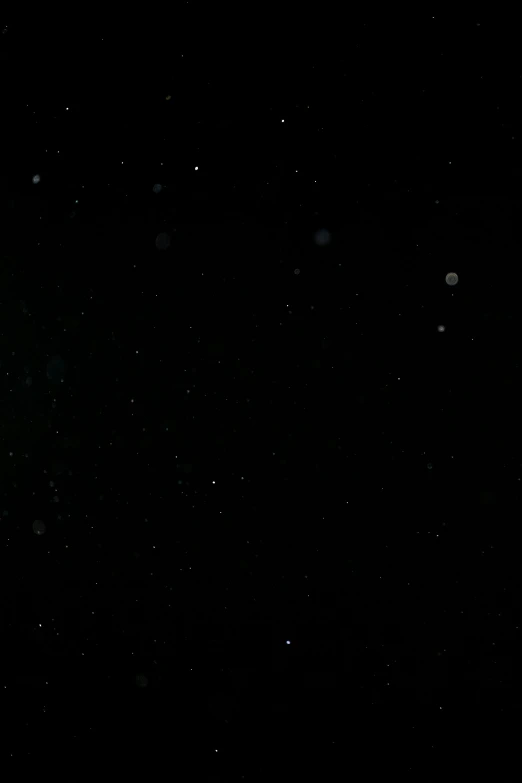 a man riding a snowboard down a snow covered slope, bubbles vfx, 2 0 7 7, view of the cosmos, raining! nighttime