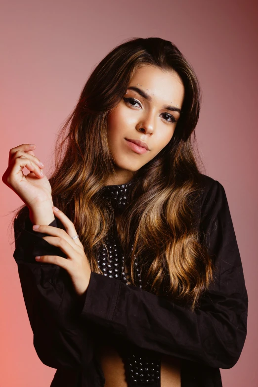 a beautiful young woman posing for a picture, by Robbie Trevino, trending on pexels, hailee steinfeld, hands in her hair, solid background, 15081959 21121991 01012000 4k