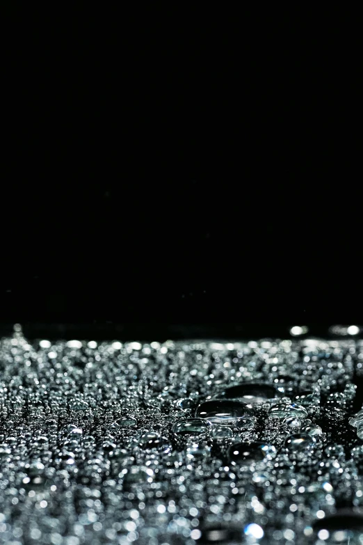 a close up of water droplets on a surface, by Ryoji Ikeda, unsplash, kinetic pointillism, full of glass. cgsociety, black ambient background, low quality footage, water on the floor