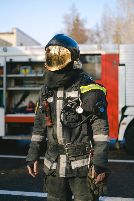 a firefighter standing in front of a fire truck, a picture, by Adam Marczyński, renaissance, space suit with a modern helmet, balaclava, wearing a flying jacket, trending photo