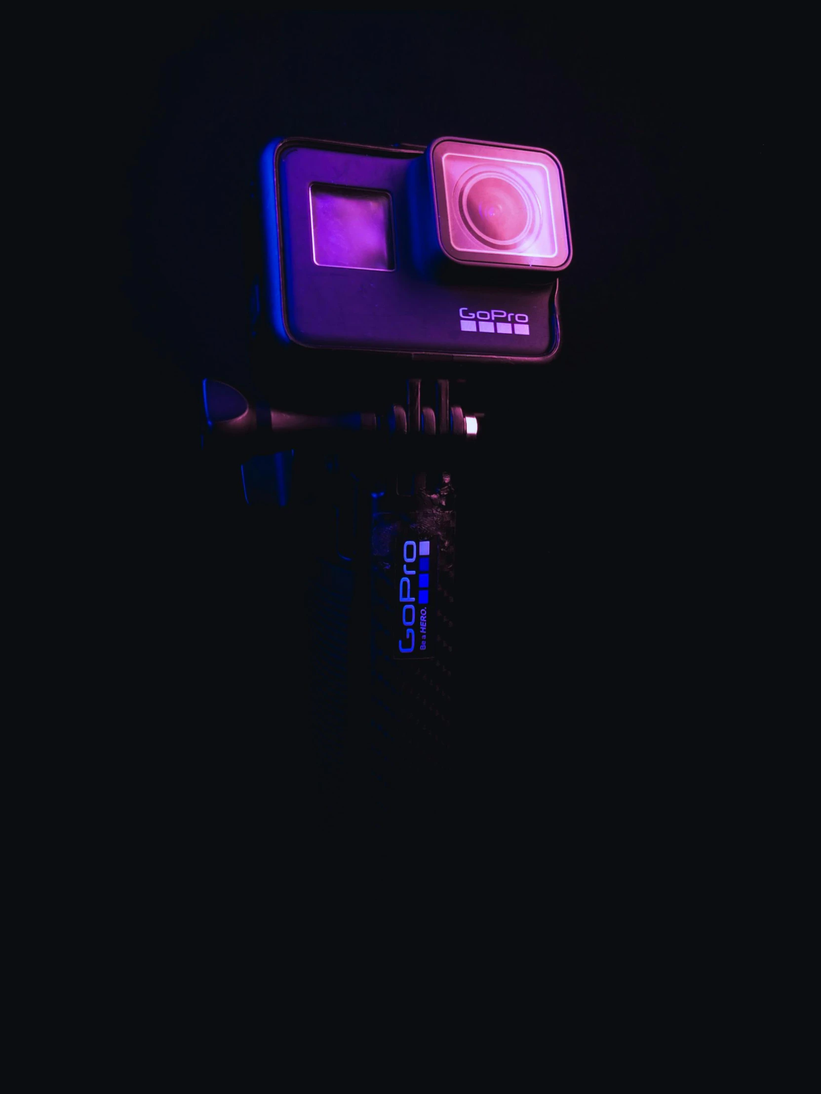 a camera sitting on top of a tripod in the dark, by Ryan Pancoast, unsplash contest winner, video art, purple and pink and blue neons, taken on go pro hero8, instagram story, underwater glow