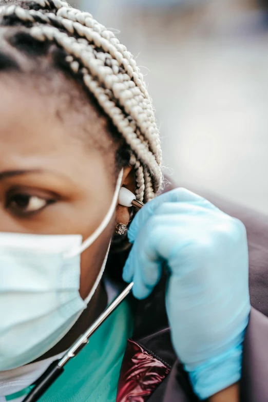 a close up of a person with a stethoscope, trending on pexels, happening, people are wearing masks, photo of a black woman, wearing gloves, concentration