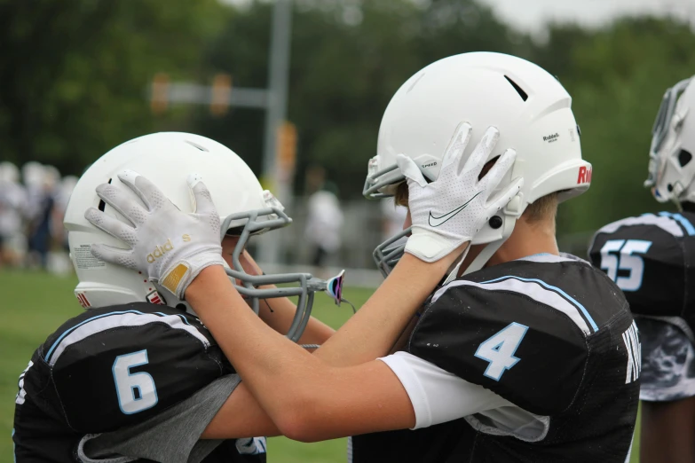 a group of young men standing next to each other on a field, a picture, by Carey Morris, shutterstock, photorealism, helmet view, tournament, hands, 15081959 21121991 01012000 4k