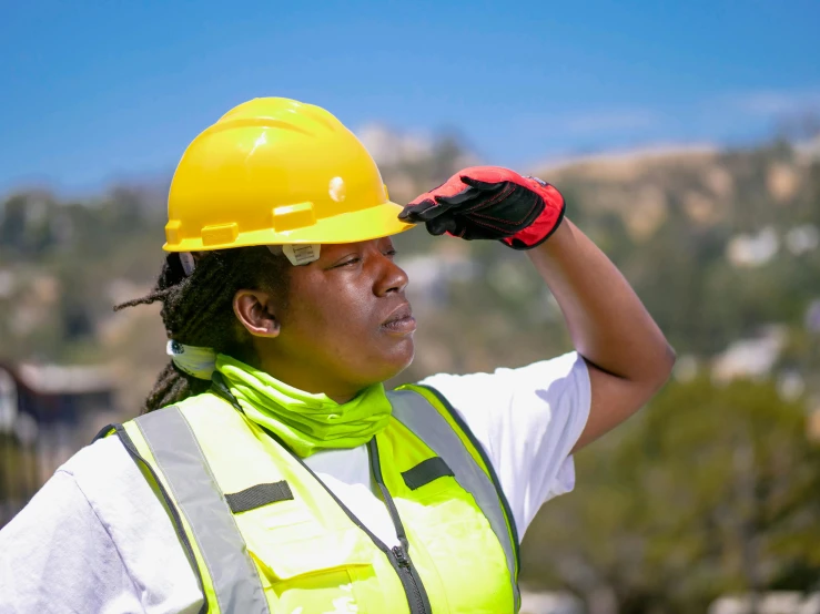 a woman wearing a hard hat and safety vest, unsplash, renaissance, in the sun, photo of a black woman, point of view of visor wearer, california;