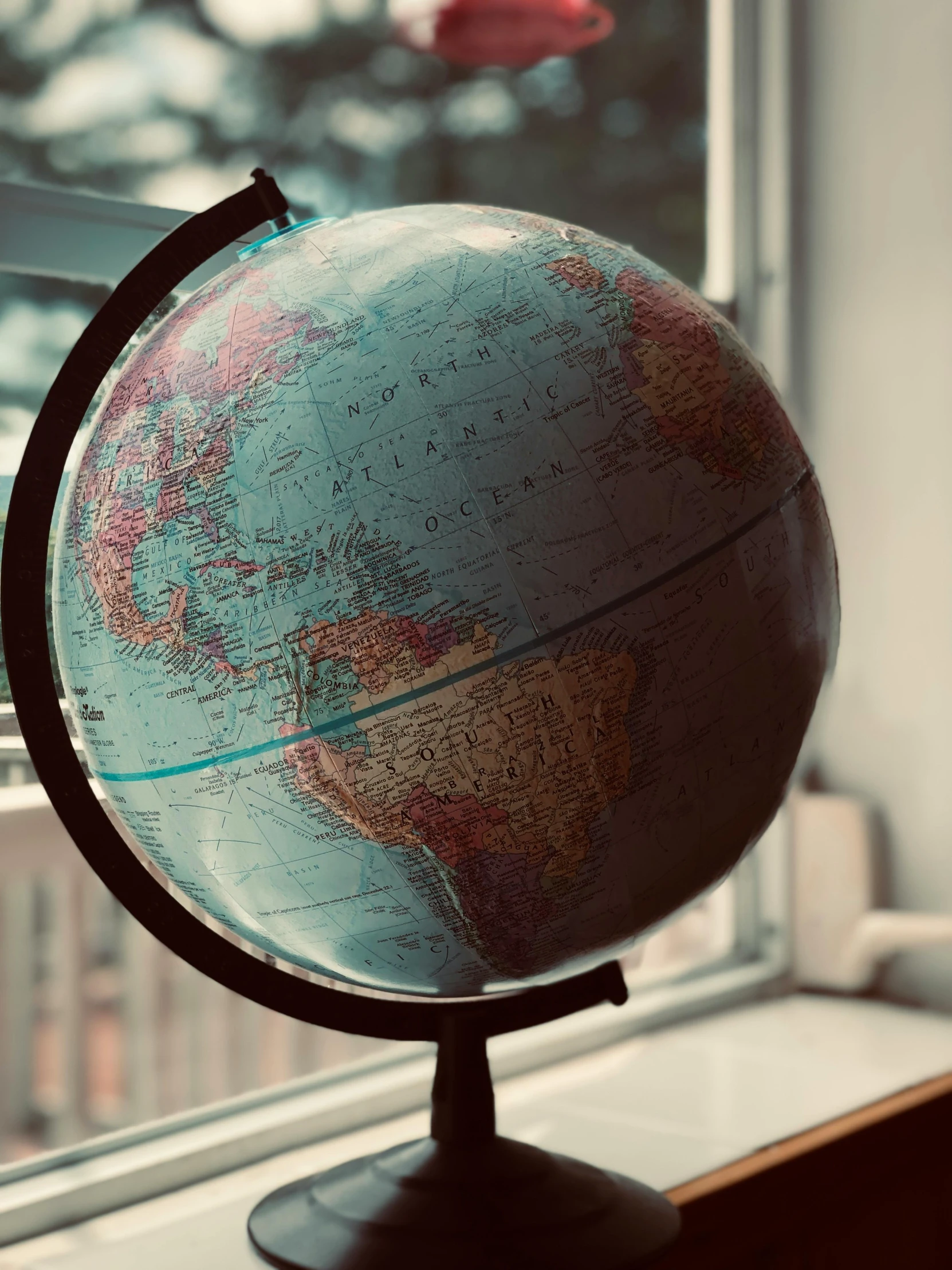 a globe sitting on top of a window sill, photograph taken in 2 0 2 0, round-cropped, map, replica model