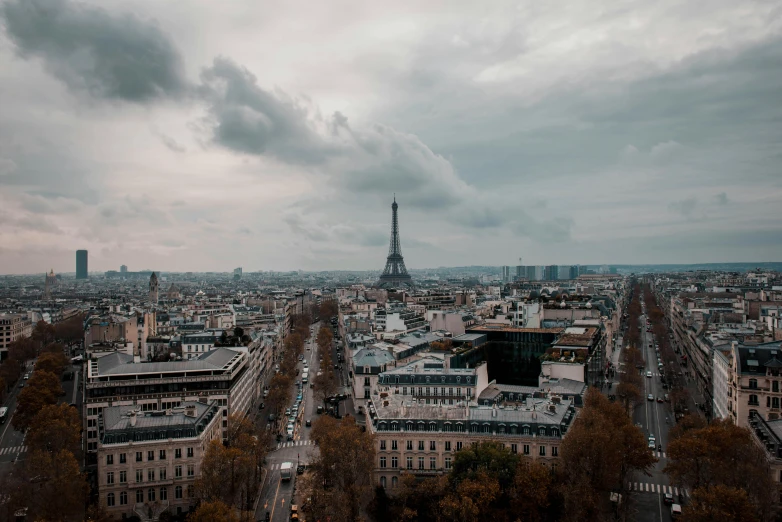 the eiffel tower towering over the city of paris, pexels contest winner, paris school, overcast gray skies, background image, carson ellis, wide high angle view