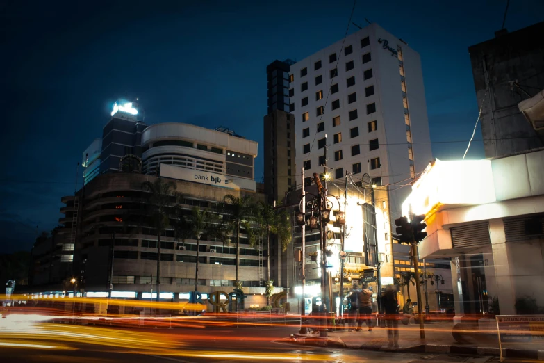 a city street filled with lots of tall buildings, unsplash, photorealism, with orange street lights, bangkok townsquare, billboard image, brutalist