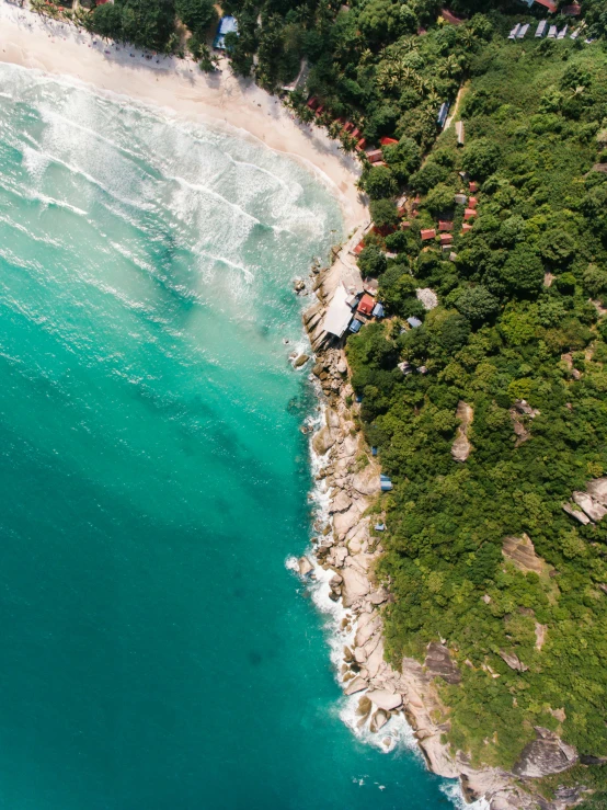 a large body of water next to a beach, pexels contest winner, airborne view, colombia, thumbnail, 8k resolution”