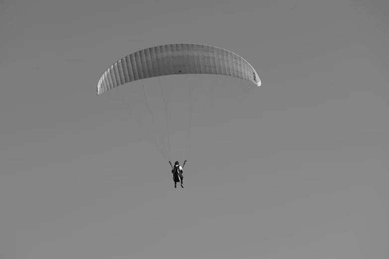 a person that is in the air with a parachute, a black and white photo, pexels contest winner, figuration libre, no words 4 k, ultra minimalistic, !! low contrast!!, shiny silver