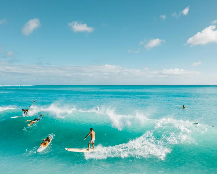 a group of people riding surfboards on top of a wave, pexels contest winner, fine art, turquoise water, o'neill cylinder colony, heaven paradise, crystal clear blue water