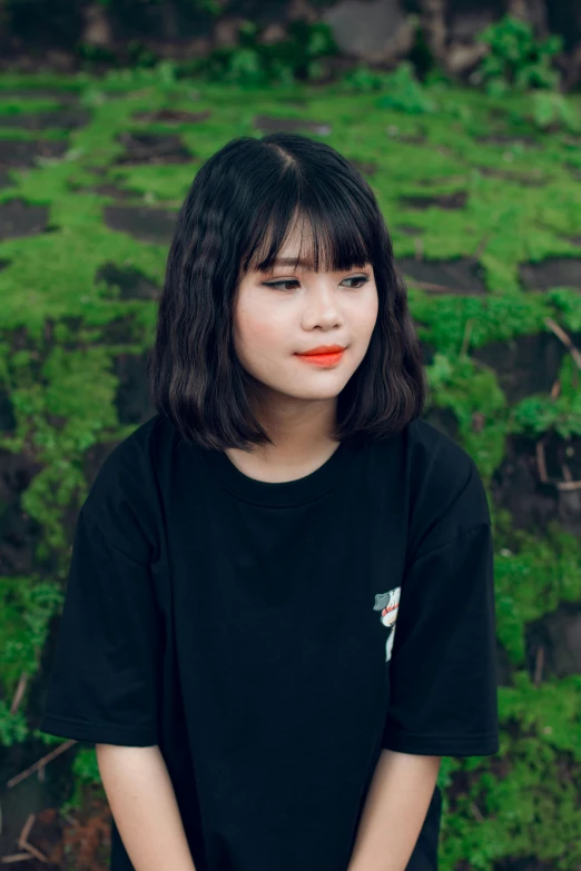 a girl in a black shirt posing for a picture, an album cover, inspired by Kim Jeong-hui, pexels contest winner, hair blackbangs hair, indonesia, thoughtful ), slightly pixelated