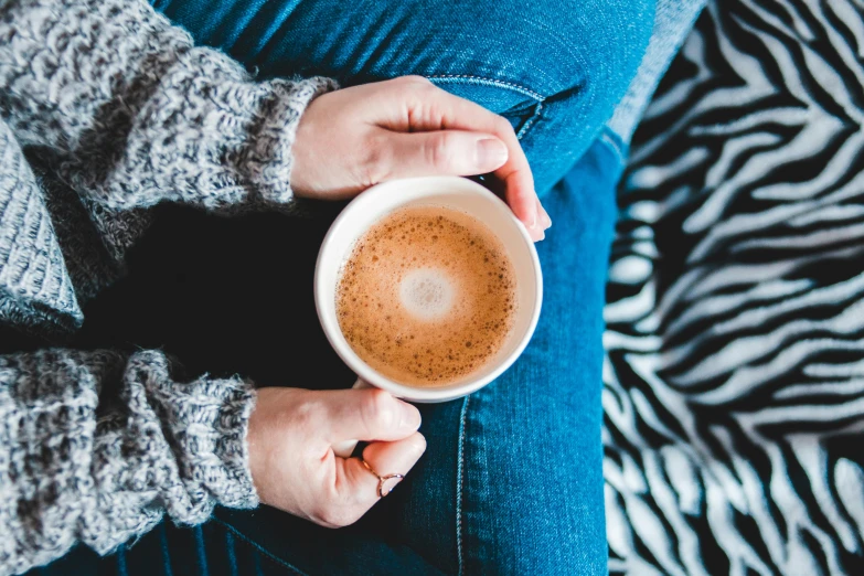 a close up of a person holding a cup of coffee, by Julia Pishtar, trending on pexels, relaxing on the couch, 15081959 21121991 01012000 4k, thumbnail, background image