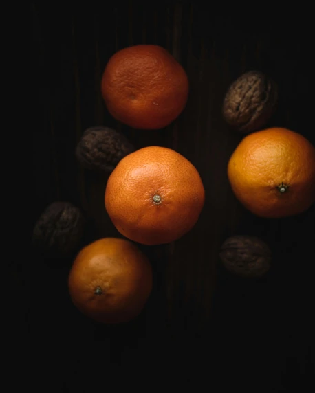 a group of oranges and walnuts on a table, by Frederik Vermehren, pexels contest winner, dark orange, brown, variations, tangerine dream album cover