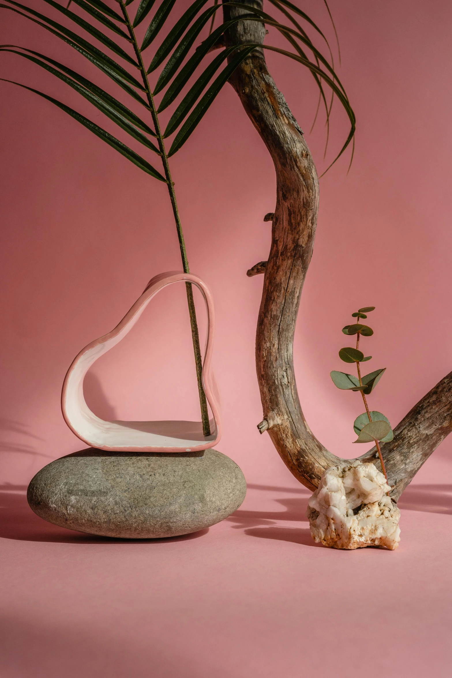 a couple of vases sitting on top of a table, an abstract sculpture, inspired by Isamu Noguchi, hearts, in pink forest, biophilia mood, driftwood