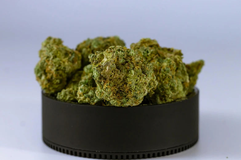 a bowl filled with green weed sitting on top of a table, nugget, detailed product image, crisp photo, premium