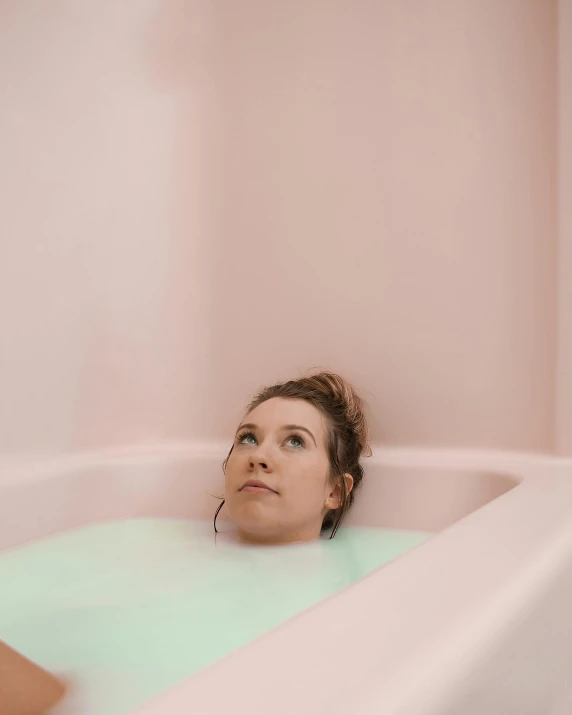 a woman taking a bath in a bathtub, a colorized photo, inspired by Elsa Bleda, trending on pexels, muted rainbow tubing, concerned expression, trending on vsco, squishy