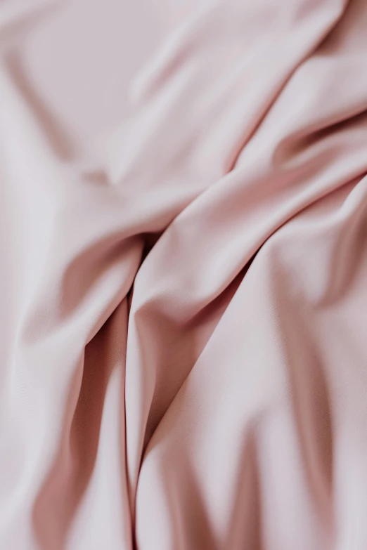 a close up of a pink sheet on a bed, inspired by Pierre-Joseph Redouté, trending on unsplash, clay material, satin, matte finish, zoomed in