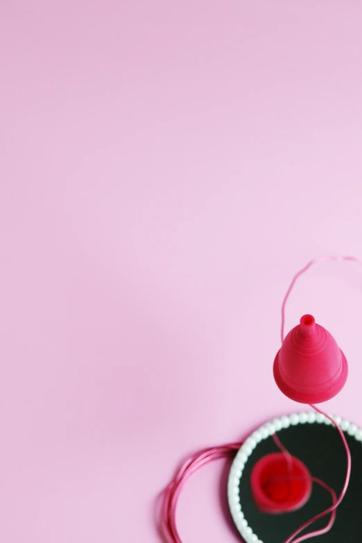 a pair of headphones sitting on top of a pink surface, a picture, by Elsa Bleda, plasticien, panties, red hat, 1614572159, contracept
