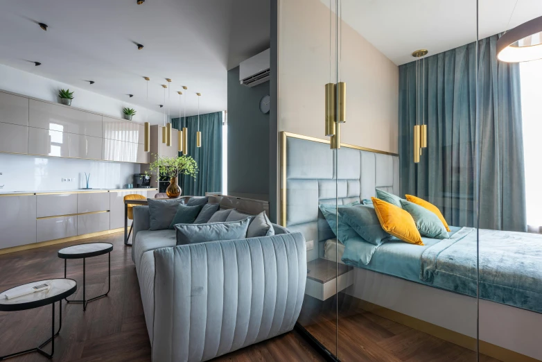 a bed sitting inside of a bedroom next to a living room, a colorized photo, by Adam Marczyński, unsplash contest winner, cyan and gold scheme, luxury condo interior, open plan, glossy surface