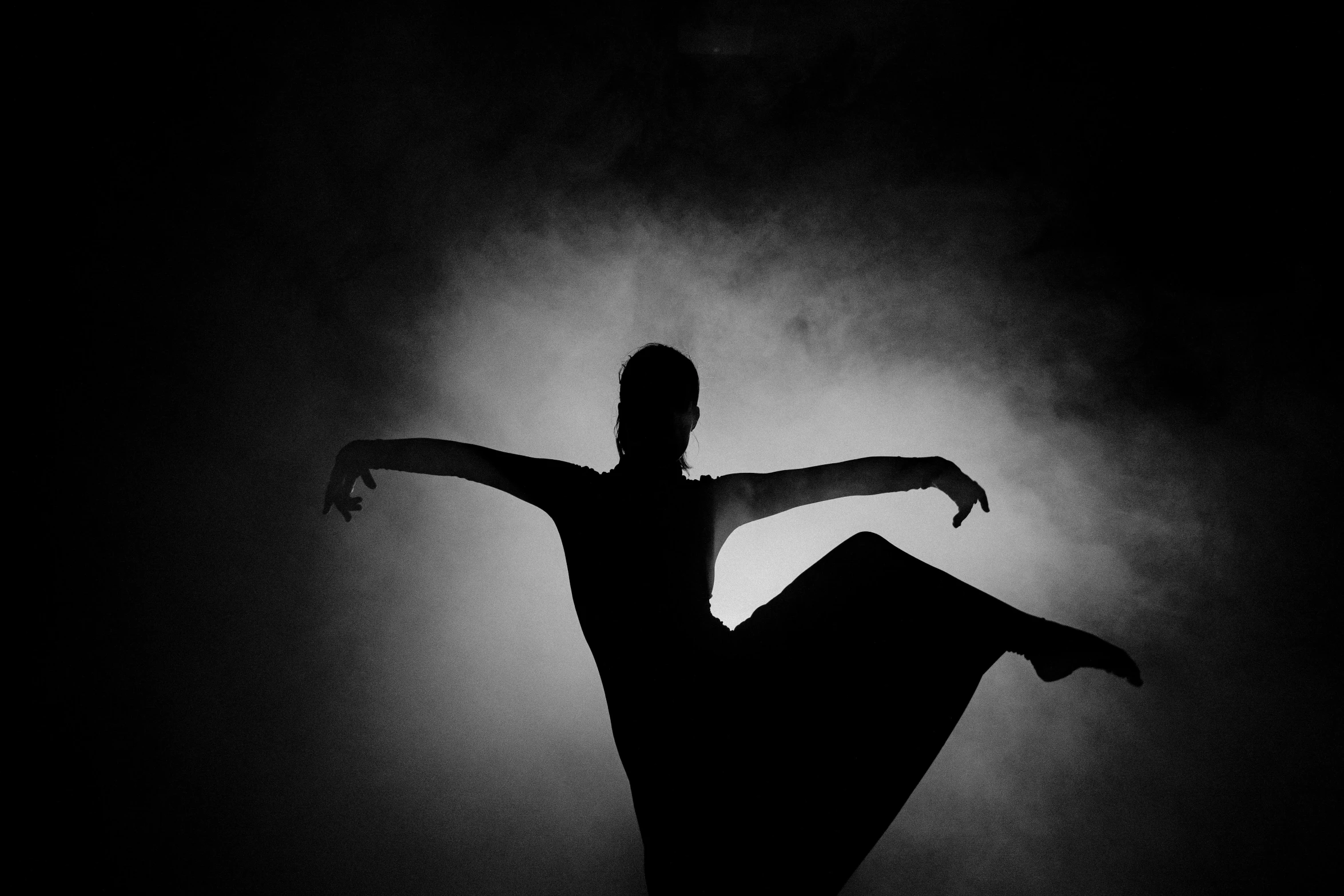 a black and white photo of a woman dancing, by Caroline Mytinger, pixabay, dark and misty, concert, character silhouette, balance