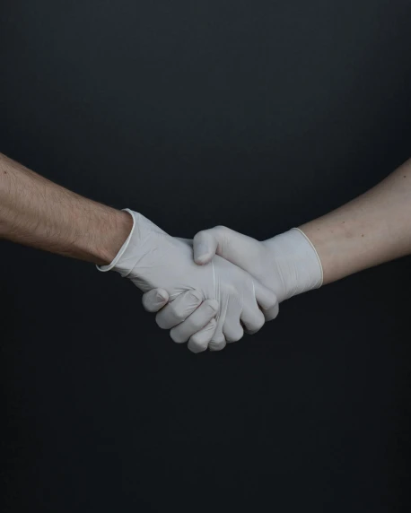 a close up of two people shaking hands, by Arabella Rankin, pexels contest winner, renaissance, bandages, trans rights, rubber and latex, out in the dark