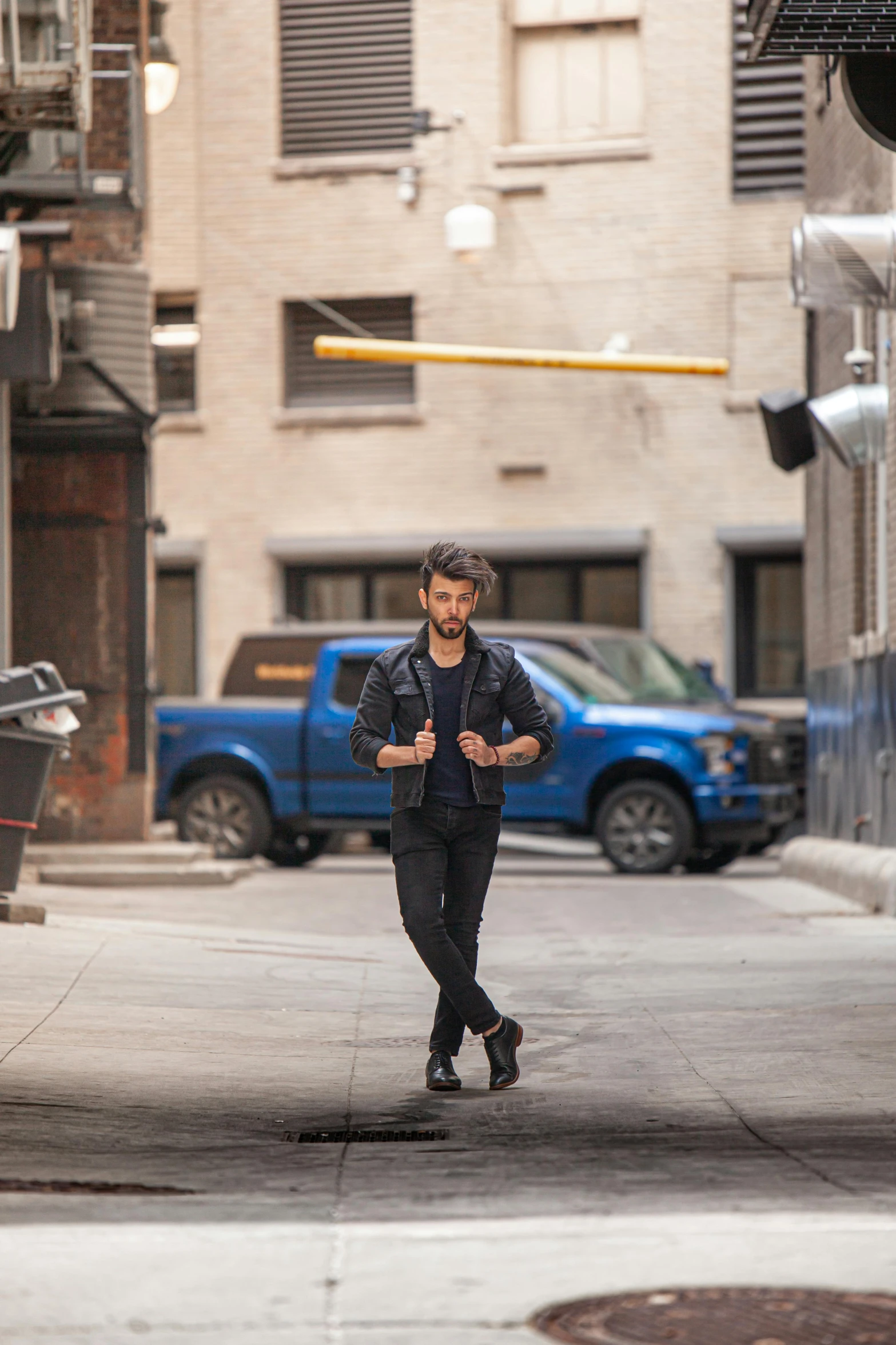 a man is running down a city street, an album cover, inspired by david rubín, trending on unsplash, renaissance, zayn malik, photorealistic logan movie still, confident pose, in front of a garage