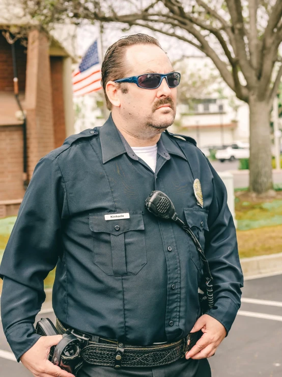 a man in a police uniform standing in a parking lot, by Andrew Stevovich, sam hyde, splash image, goatee, cinematic outfit photo