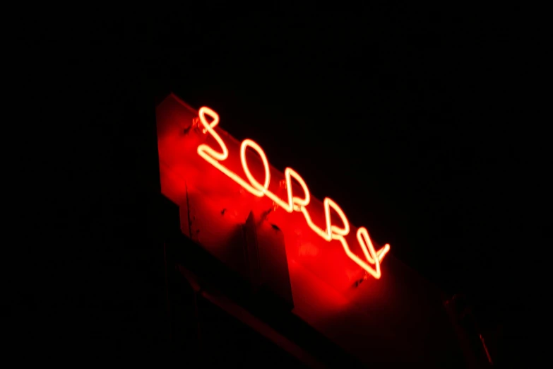 a neon sign on the side of a building, inspired by Nan Goldin, pexels, forgiveness, soup, facepalm, 2006 photograph