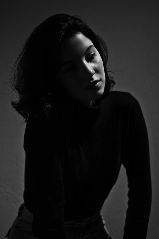 a black and white photo of a woman, dark light, bella poarch, ( low key light ), woman with black hair