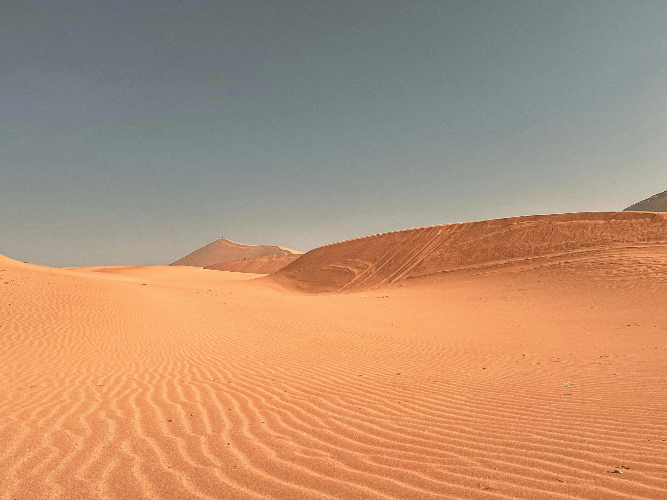 a man riding a surfboard on top of a sandy beach, an album cover, pexels contest winner, hurufiyya, barren desert landscape, beautiful panoramic imagery, tuareg, youtube thumbnail