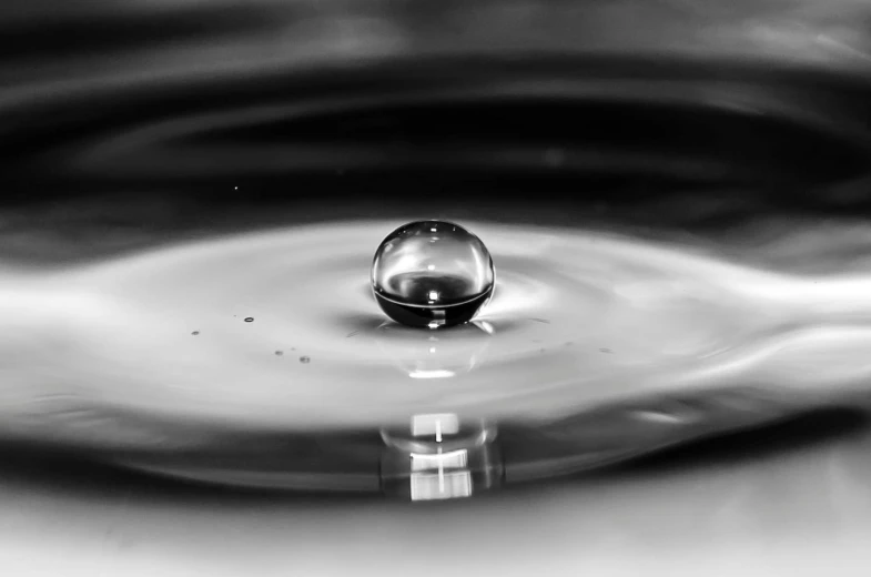 a black and white photo of a drop of water, by Jan Rustem, pexels, sphere, photorealistic image, liquid metal, water element