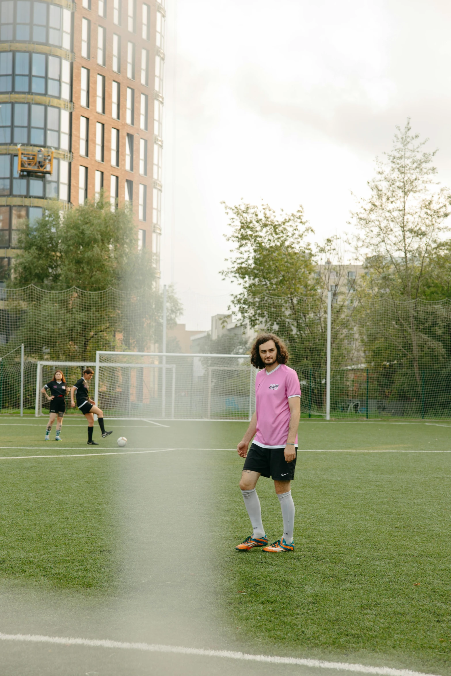 a group of young men playing a game of soccer, by Jacob Toorenvliet, unsplash, happening, panoramic view of girl, non-binary, medium shot portrait, anton fadeev 8 k