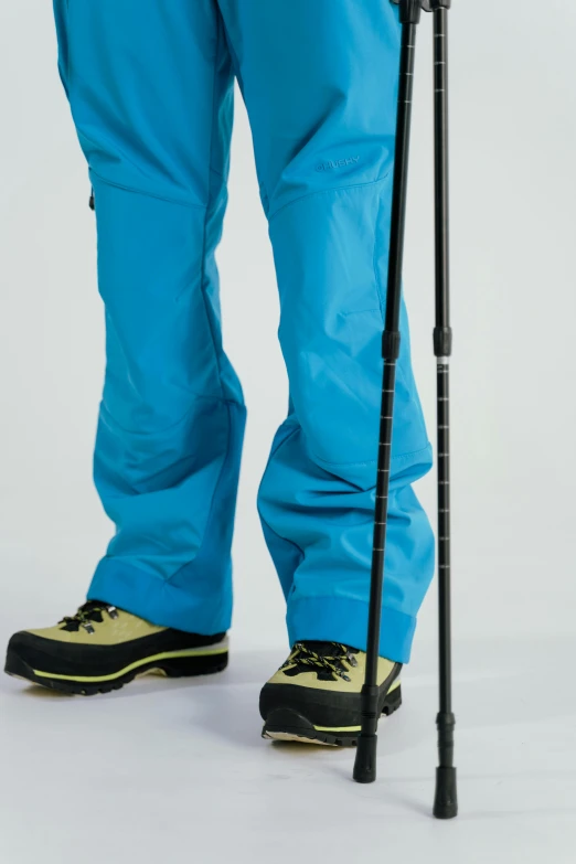 a person with a pair of skis and poles, by Jens Søndergaard, light blue, large pants, view(full body + zoomed out), ultra - detail